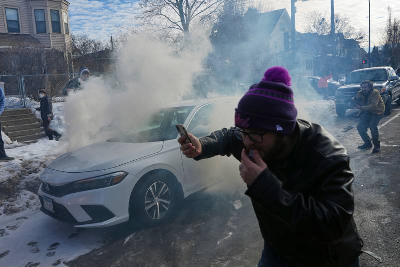 Protesters try to avoid tear gas dispersed by federal agents, Monday, Jan. 12, 2026 in Minneapolis (AP Photo/Adam Gray)