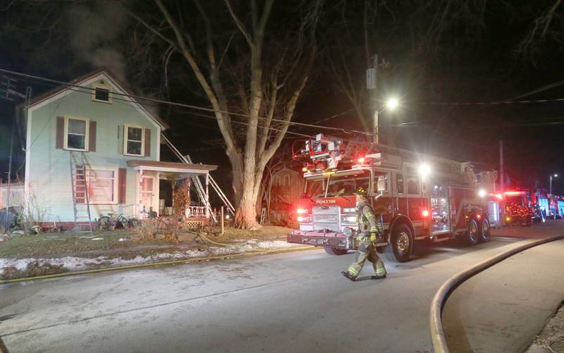 Firefighters work the scene of a structure fire in the 300 block of South Chestnut Street on Friday, Dec. 19, 2025 in Princeton. Fire departments from  from Malden, Bureau, Walnut, Princeton, Spring Valley, Ladd and Wyanet all responded to the scene.