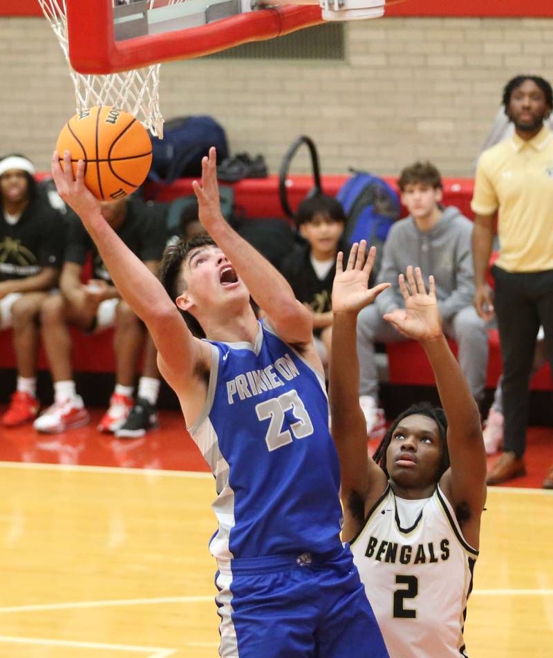 Princeton's Noah LaPorte eyes the hoop as Oak Forest's Cameron Lee defends during the Dean Riley Shootin' The Rock Thanksgiving Tournament on Tuesday, Nov. 26, 2024 in Kingman Gym at Ottawa High School.