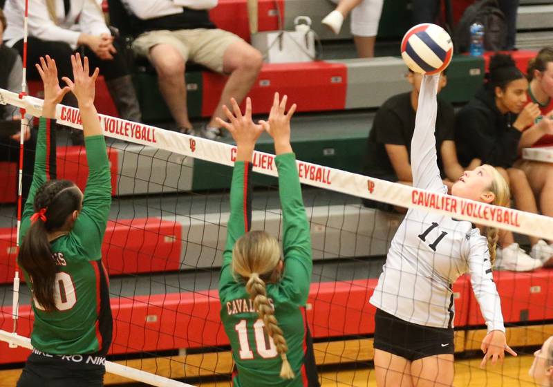 Kaneland's Abigail Carter spikes the ball past L-P's Anna Riva and teammate Kelsey Frederick in AJ Sellett Gymnasium on Thursday, Oct. 24, 2024 at L-P High School.