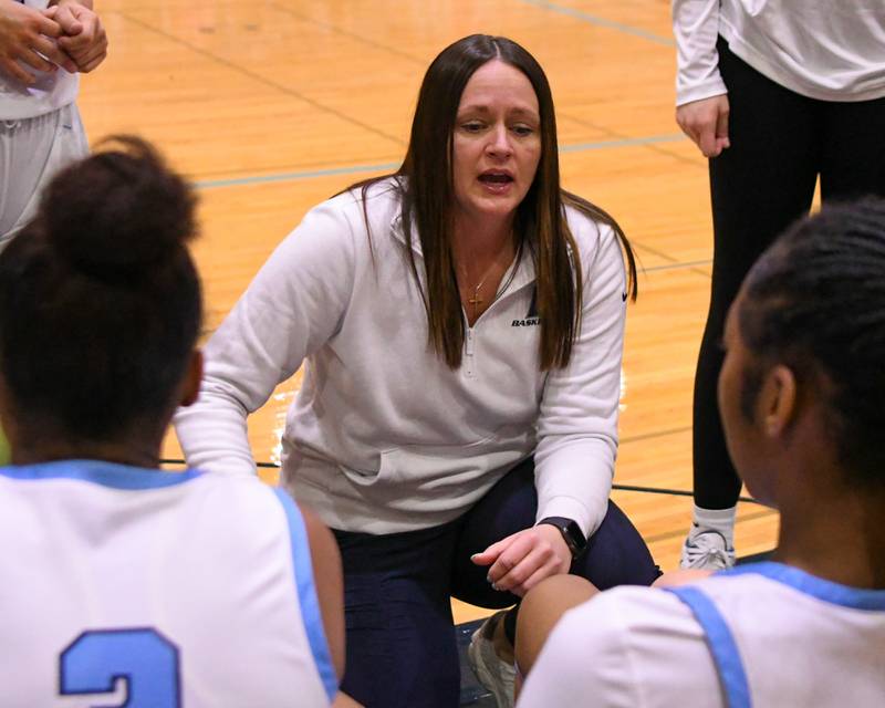 Downers Grove South's head coach Lyndsie Long talks to the team between quarters during the game on Saturday Dec. 21, 2024, while taking on Downers Grove North held at Downers Grove South High School.