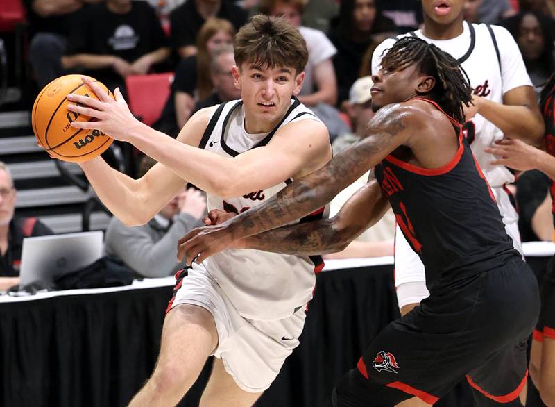 Benet’s Edvardas Stasys goes baseline against Auburn's Amir Danforth Monday, March 9, 2026, during their IHSA Class 4A supersectional matchup in the Convocation Center at Northern Illinois University in DeKalb.