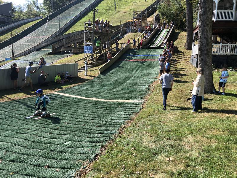 The first jumpers on Saturday, Oct. 4, 2025, at Norge Ski Club's annual Jumptoberfest tournament. Athletes - including to children just entering the sport- jumped on all of the hills in 80-degree weather.