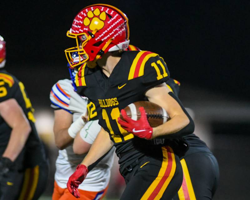 Batavia's Brett Berggren (11) runs the ball during the first round of playoffs on Friday Oct. 31, 2025, while taking on Hoffman Estate held at Batavia High School.