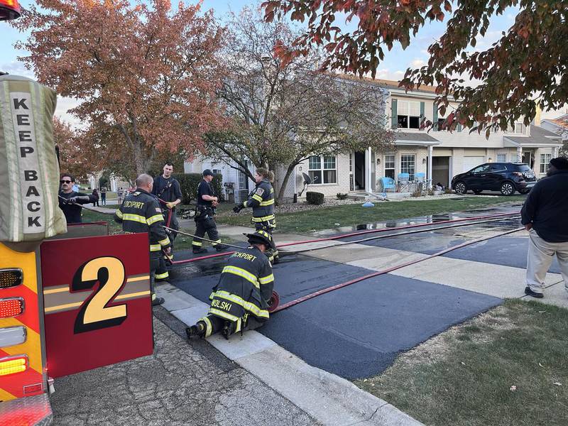 Lockport Township Fire Protection District crews block off the scene of a fire in the 1400 Block of Root Street in Crest Hill.
