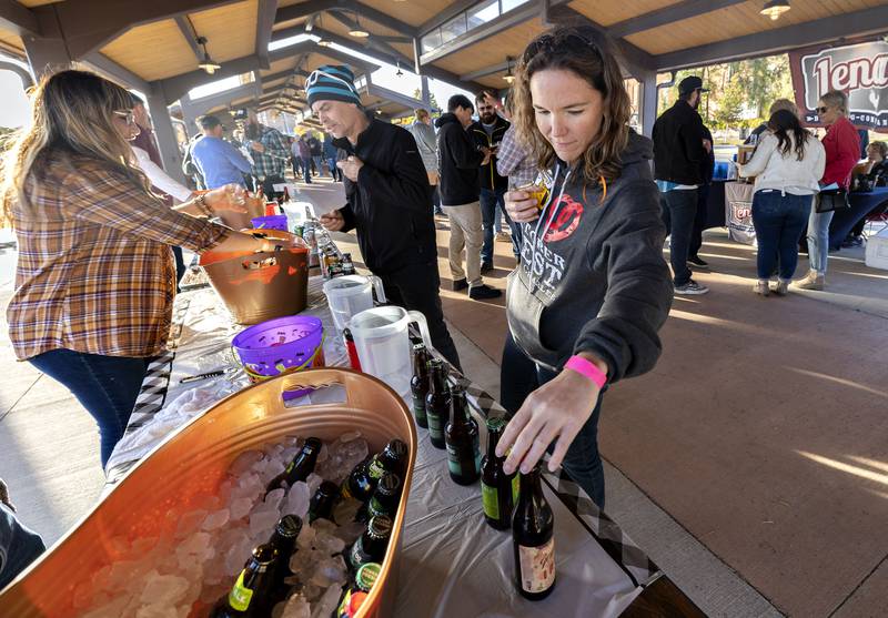 Julie Morgan of Rock Falls looks over a selection of beers being offered Saturday, Oct. 8, 2022 at Sterling Main Streets Hops on the Rock. Held at Sterling Marketplace, the event featured dozens of beers, food and music.