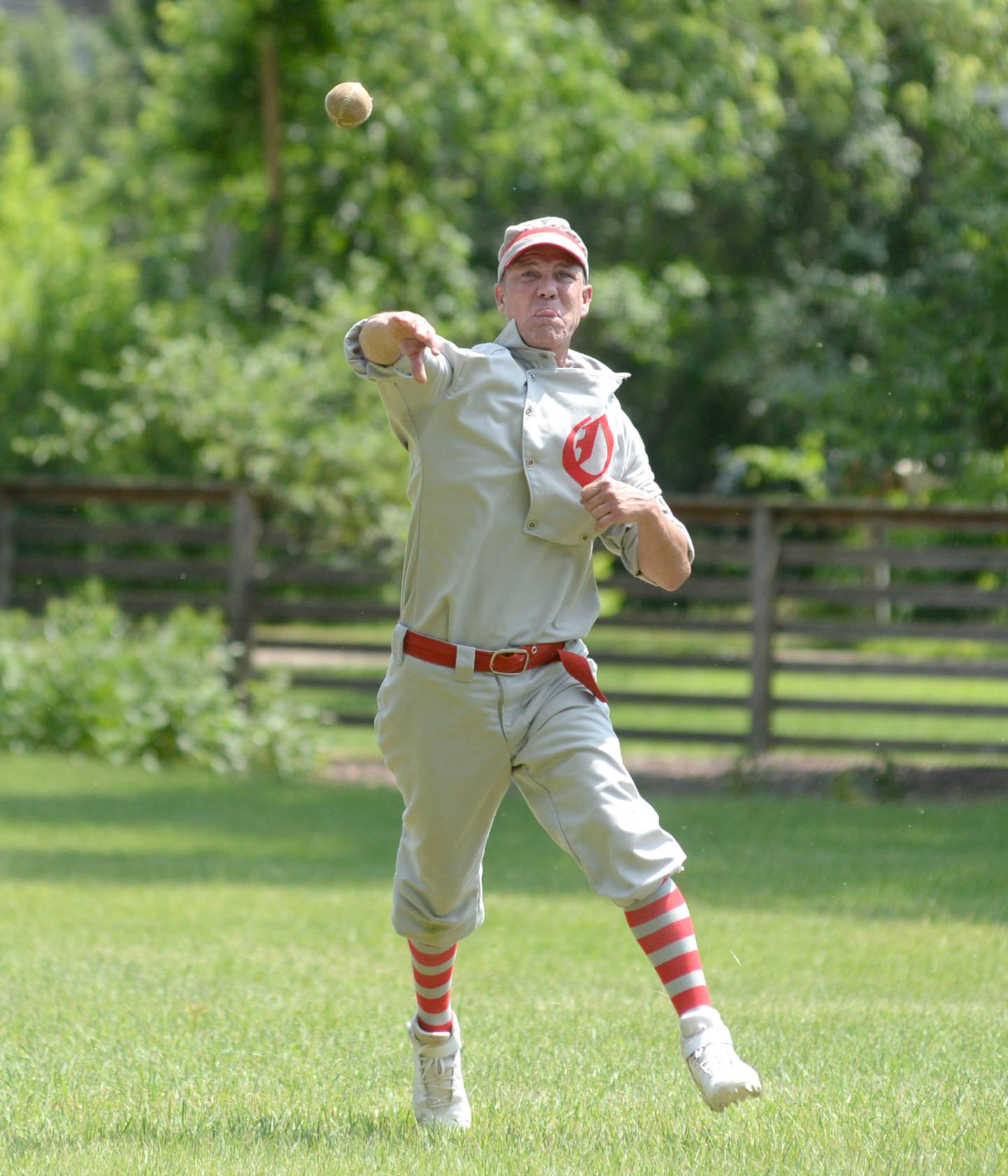 Bill "Dollar Bill" Roschi throws to first after fielding a grounder at third base  during the Oregon Ganymedes' Vintage Base Ball game with the DuPage Plowboys on Saturday, June 3 at the John Deere Historic Site in Grand Detour.