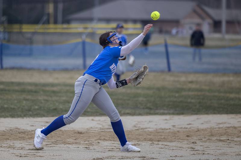 Newman’s Lucy Oetting throws to first for an out against Annawan-Wethersfield Wednesday, March 22, 2023.