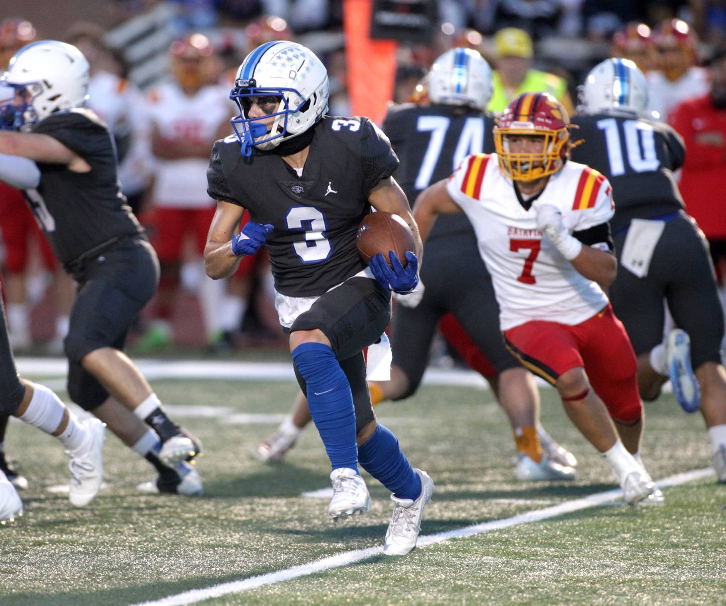 St. Charles North’s Jake Mettetal carres the ball during a home game against Batavia on Friday, Sept. 15, 2023.