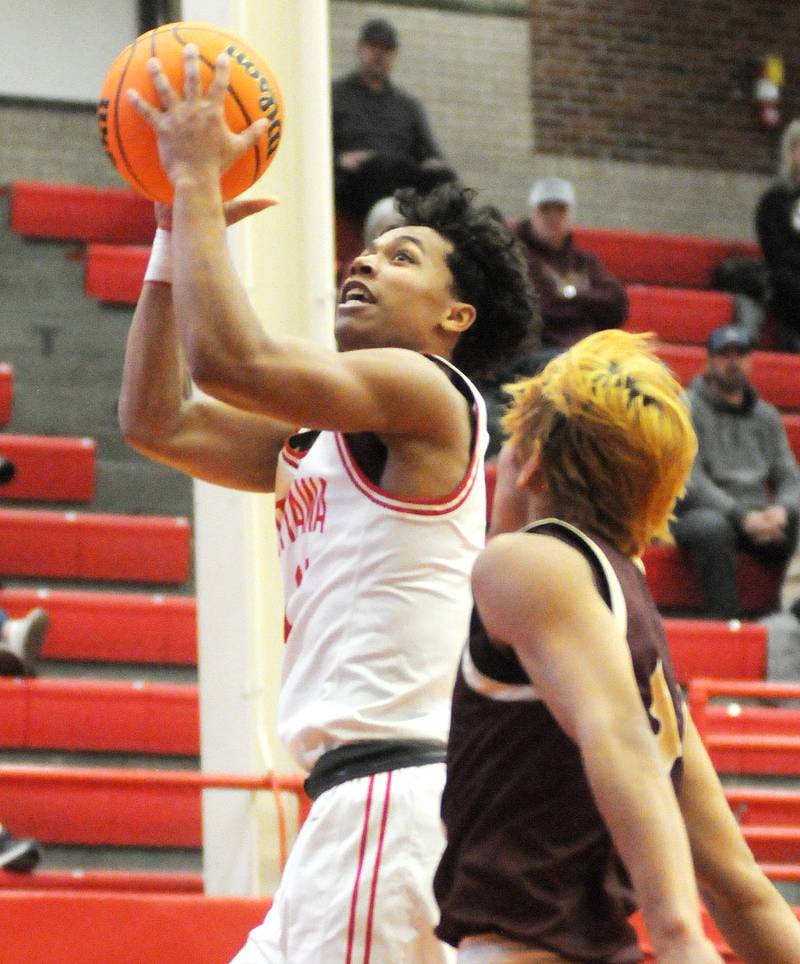 Ottawa senior Hezekiah Joachim shoots past the defense of Morris senior Luis Loza on Friday, Dec. 12, 2025 at Kingman Gym.