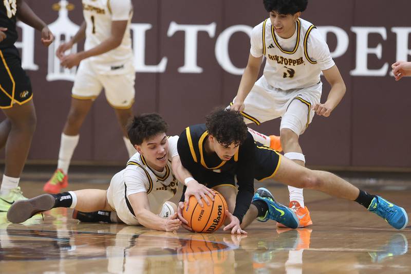 Joliet Catholic’s Charlie Czerkies and Elmwood Park’s Scotty Ruiz battle for the loose ball in the Class 3A Joliet Catholic Regional semifinal game on Wednesday, Feb. 25, 2026 in Joliet.