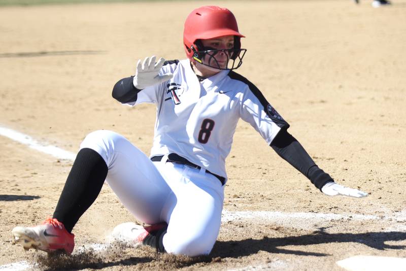 Bradley-Bourbonnais' Evie McIntyre slides into home plate for a run during a home game against Herscher Monday, March 24, 2025.