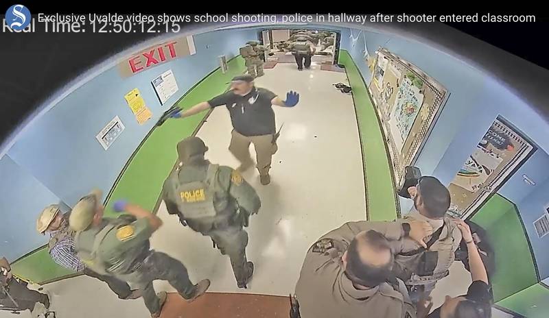 FILE - In this photo from surveillance video provided by the Uvalde Consolidated Independent School District via the Austin American-Statesman, authorities respond to the shooting at Robb Elementary School in Uvalde, Texas, on May 24, 2022. Nearly 400 law enforcement officials rushed to the mass shooting that left 21 people dead at the elementary school but “systemic failures” created a chaotic scene that lasted more than an hour before the gunman was finally confronted and killed, according to a report from investigators released Sunday, July 17, 2022. (Uvalde Consolidated Independent School District/Austin American-Statesman via AP, File)