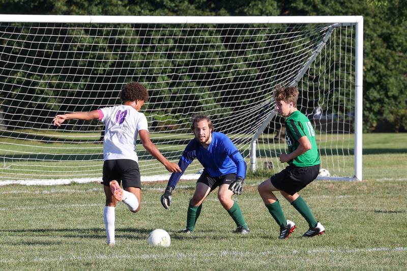 Bishop McNamara goalkeeper Matthew Buzas and defender Aiden Belcher look to block a shot on goal by Manteno's Justin Foster, left, during the Panthers' 10-0 victory over Bishop McNamara on Monday, Sept. 8, 2025.