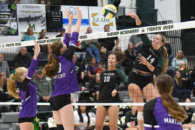 Bishop McNamara's Kate Dole, right, sends a hit over the net during a home game against Manteno Monday, Oct. 20, 2025.