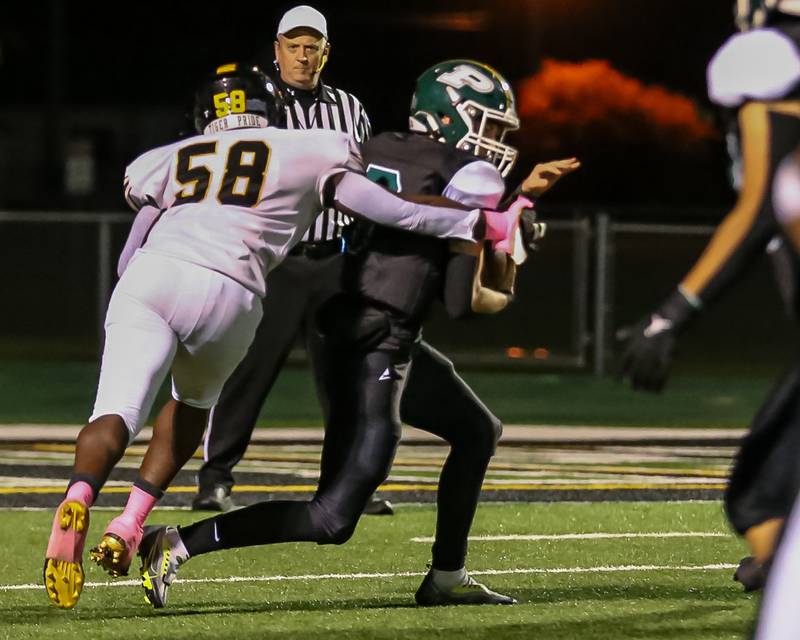 Joliet West's Nyles Tate (58) sacks Plainfield Centrals Matt Leto (7) during football game between Joliet West at Plainfield Central.   Oct 20, 2023.