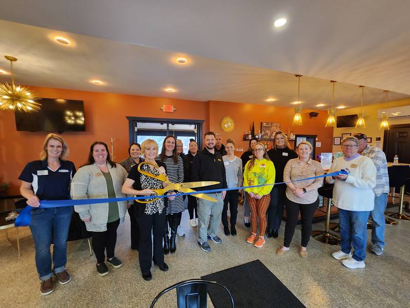 The Genoa Area Chamber of Commerce welcoming Cougars with a ribbon-cutting