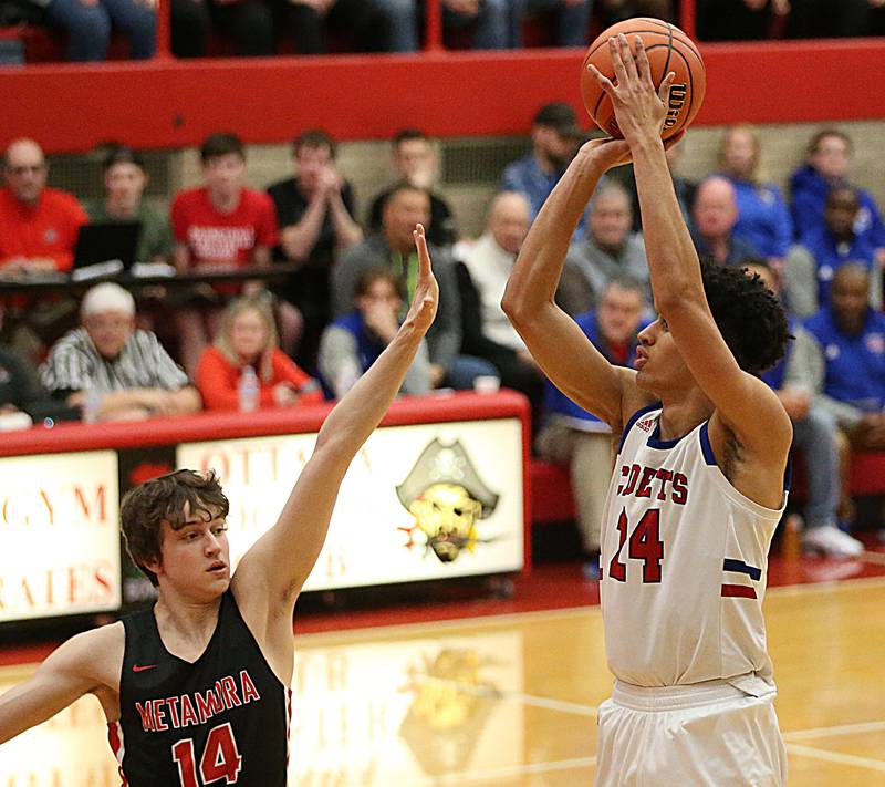Marmion's Travon Roots shoots a jump shot over Metamora's Luke Hopp during the Class 3A Super-Sectional on Monday, March 6, 2023 at Ottawa High School.
