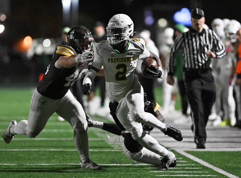 Providence Catholic's Xavier Coleman (2) picks up big yards after the catch during the conference game against Joliet Catholic on Friday, OCT. 24, 2025, at Joliet.