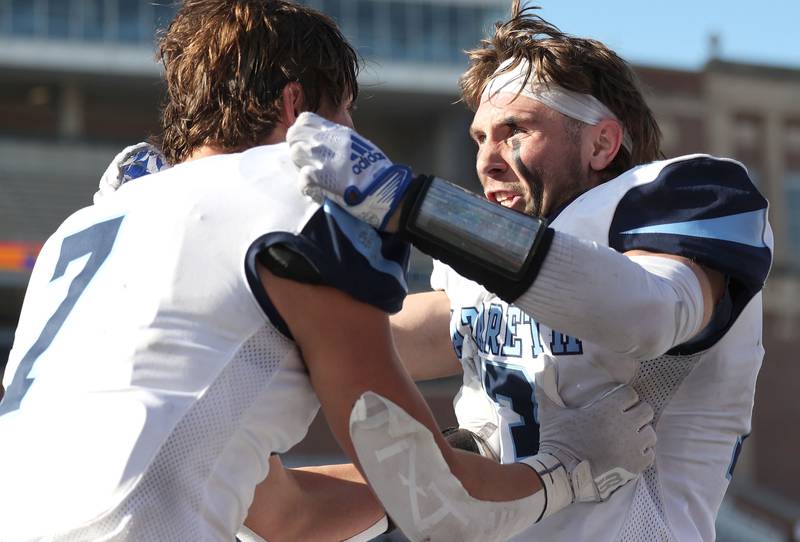 Nazareth's Zach Hayes (left) and Brady Gorman celebrate their IHSA Class 5A state championship win over Peoria Saturday, Nov. 26, 2022, in Memorial Stadium at the University of Illinois in Champaign.