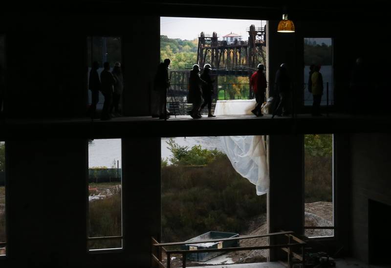 People walk on the new track while looking out at the Illinois River and Ottawa Rail Bridge at the new YMCA building on Thursday, Oct., 19, 2023 in Ottawa.