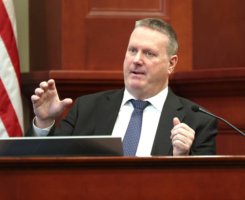 Retired DeKalb County sheriff’s Detective John Holiday testifies Monday, Jan. 27, 2025, on day three of the Jonathan D. Hurst trial at the DeKalb County Courthouse in Sycamore. Hurst is charged in the 2016 slayings of Sycamore elderly mother and son Patricia and Robert Wilson.