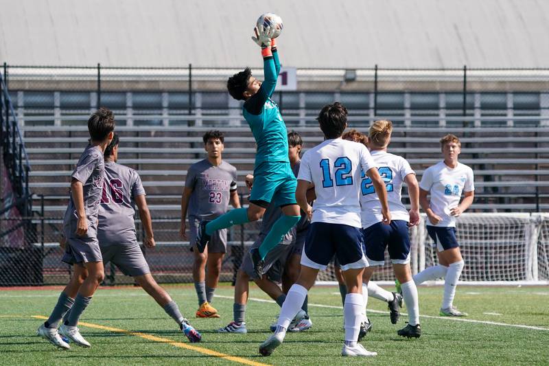 Morton’s Miguel Jimenez (0) goes up for a save against Downers Grove South during a soccer match at Morton High School in Berwyn on Saturday, Oct. 5, 2024.