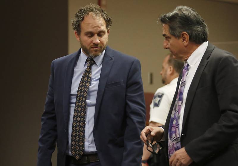 Nathan Rigg talks with his attorney, Patrick Campanelli, Tuesday, Aug. 30, 2022, during his jury trial before Judge Michael Coppedge in the McHenry County courthouse in Woodstock. Rigg was charged with two counts of predatory criminal sexual assault of a child younger than age 13, a Class X felony. Rigg was accused of sexually abusing a 4-year-old child in 2019, according to court records. The case was investigated by the Woodstock Police Department, and a warrant was issued for his arrest in March 2020.