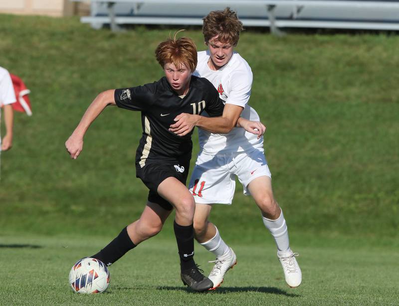 Sycamore's Jameson Carl tries to hold off La Salle-Peru's Jason Curran during their game Wednesday, Sept. 7, 2022, at Sycamore High School.