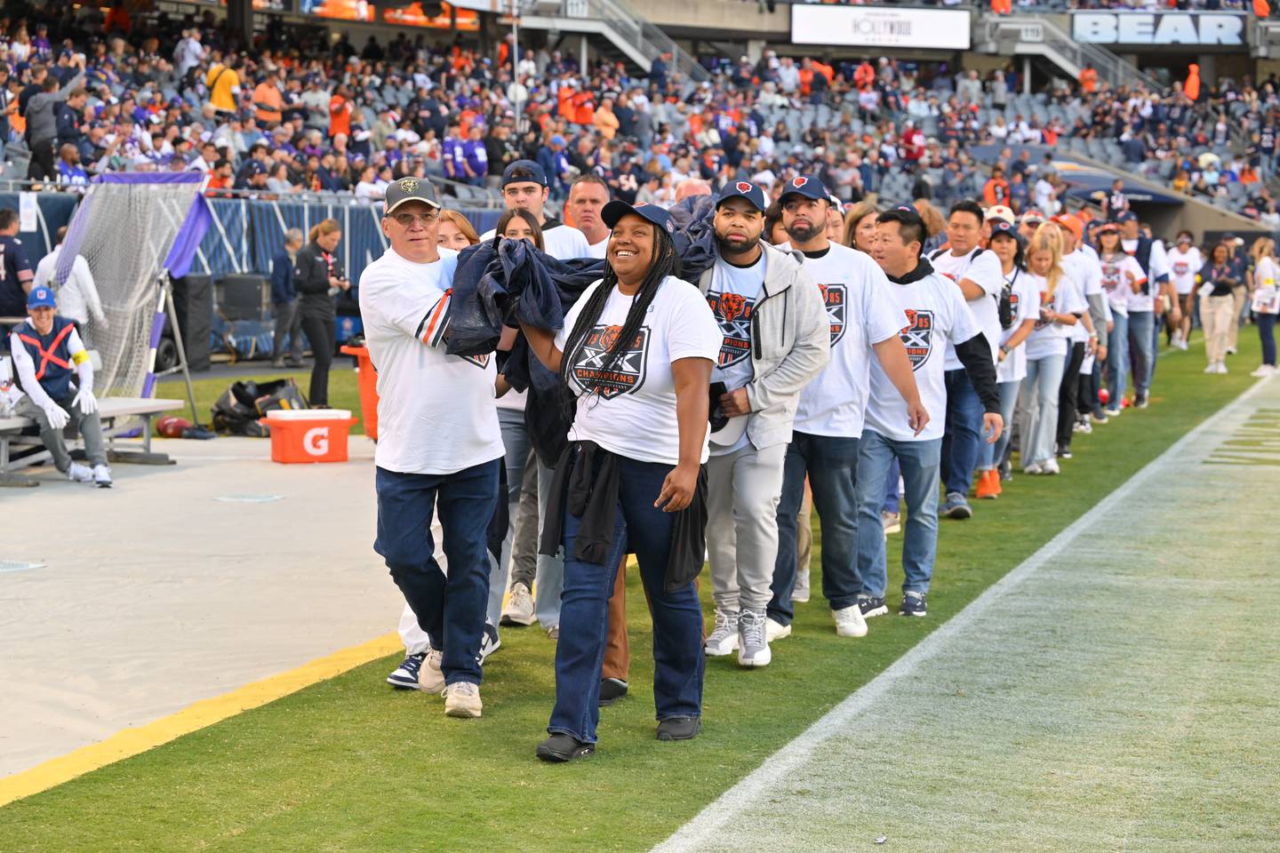 Candice Porter walks onto the field with the Bear Down flag at the Bears vs. Vikings game on Sept. 8.