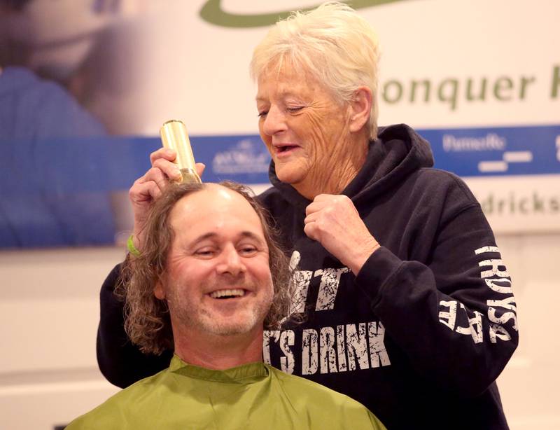 Troy Edwards owner of Troy's Place in Arlington, has his "first swipe" of hair taken off by bartender Cindy Lord, during the 18th annual Illinois Valley Emergency Services St. Baldrick's event on Sunday, March 23, 2025 at Senicas Oak Ridge in La Salle.