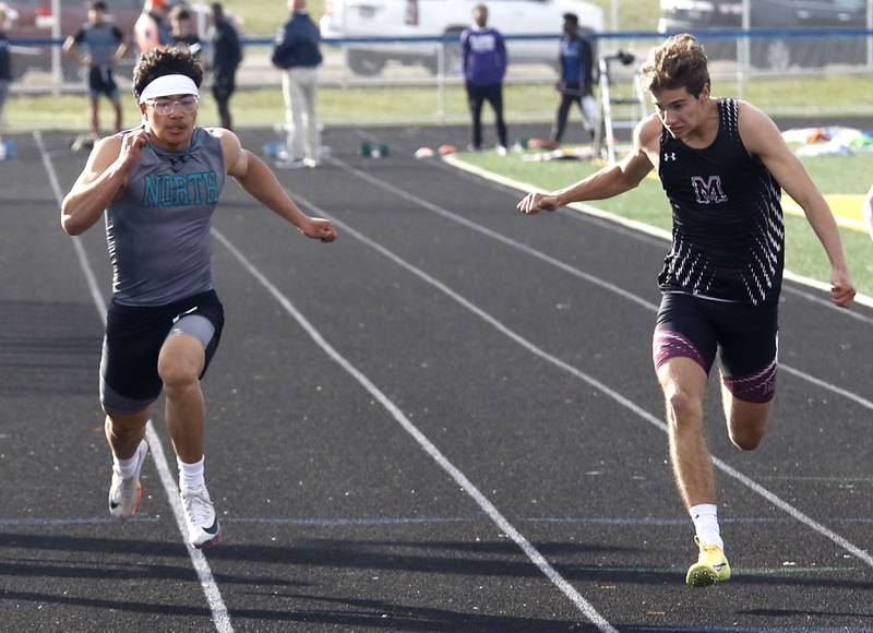 Marengo’s Jackson Heimsoth (right) beats Woodstock North’s Jovan Suay to the finish line to win the 100 meter dash during the Kishwaukee River Conference Boys Track and Field Meet on Tuesday, May 12, 2026, at Johnsburg High School.