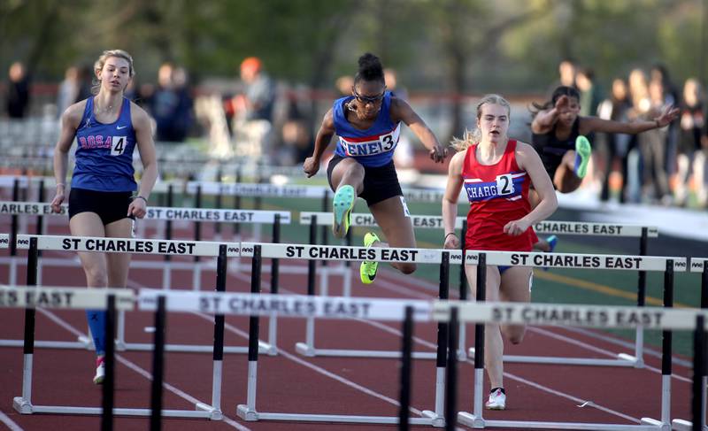 Geneva’s Alyssa Flotte (center) competes in the 100-meter hurdles during the 2024 Kane County Girls Track and Field meet at St. Charles East on Thursday, April 25, 2024.