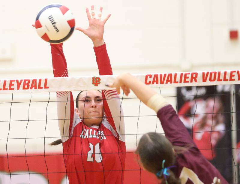 L-P's Anna Riva blocks a spike from Morris's Olivia Peterson during the Class 3A Sectional semifinal game on Tuesday, Nov. 4, 2025 in Sellett Gymnasium at L-P High School.