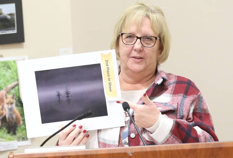Tammy Zellers holds her 2nd place in show photo of a lake in Georgia during the Starved Rock Photography Show awards on Saturday, Jan. 4, 2024 at the Starved Rock Visitors Center.
