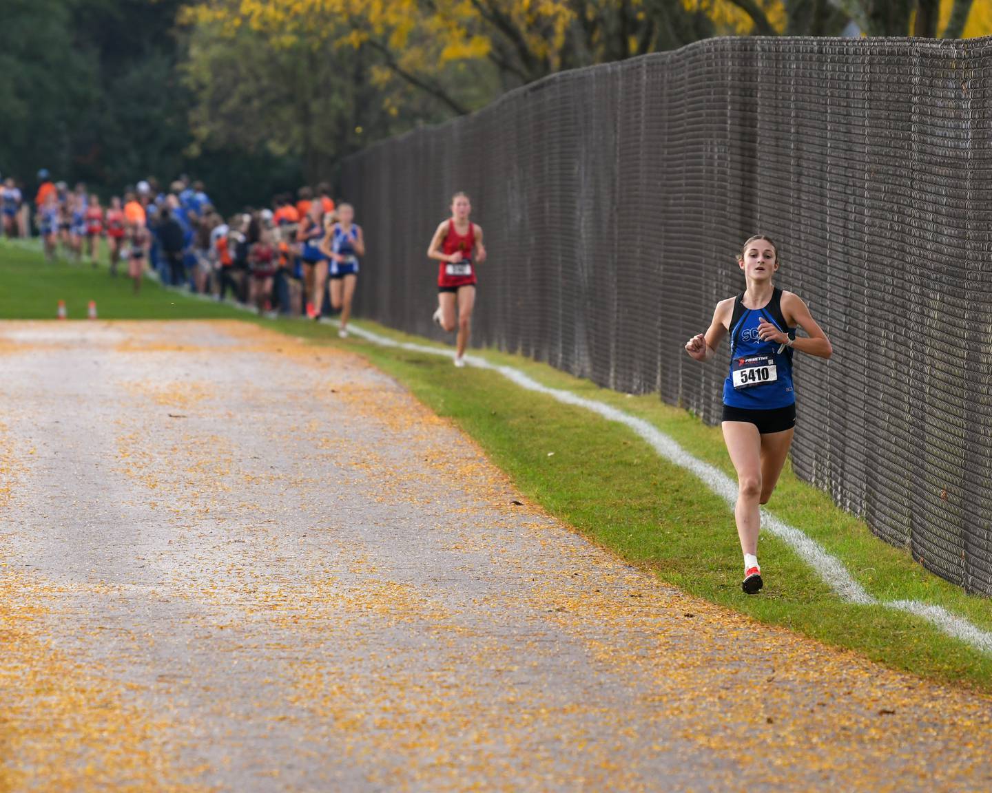 Kara Glenn of St. Charles North leads the varsity race during the DuKane Conference meet on Saturday Oct. 18, 2025, held at Lake Park High School East's campus where she finished first with a time of 16:54.9.