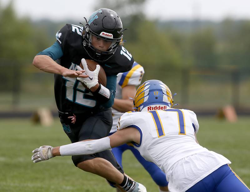 Woodstock North's Landan Creighton tries to get away from the tackle attempt of Johnsburg's Kaeden Frost during a Kishwaukee River Conference football game Saturday, Aug. 26, 2023, at Woodstock North High School.