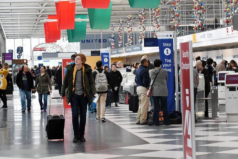 Passengers make their way through O'Hare International Airport's Terminal 1. Air travel is estimated to grow by 14% over the holiday, AAA estimates.