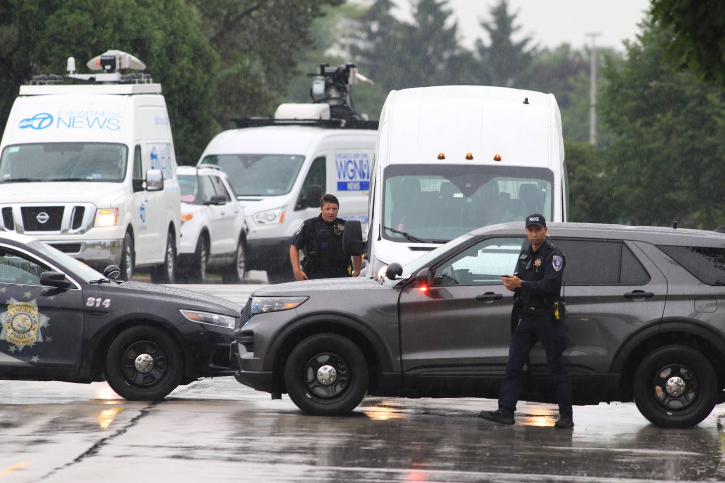 Bolingbrook Police squad cars block the roadway at the WeatherTech complex on Saturday, June 25, 2022. Early reports indicated three people were shot and one person was killed.