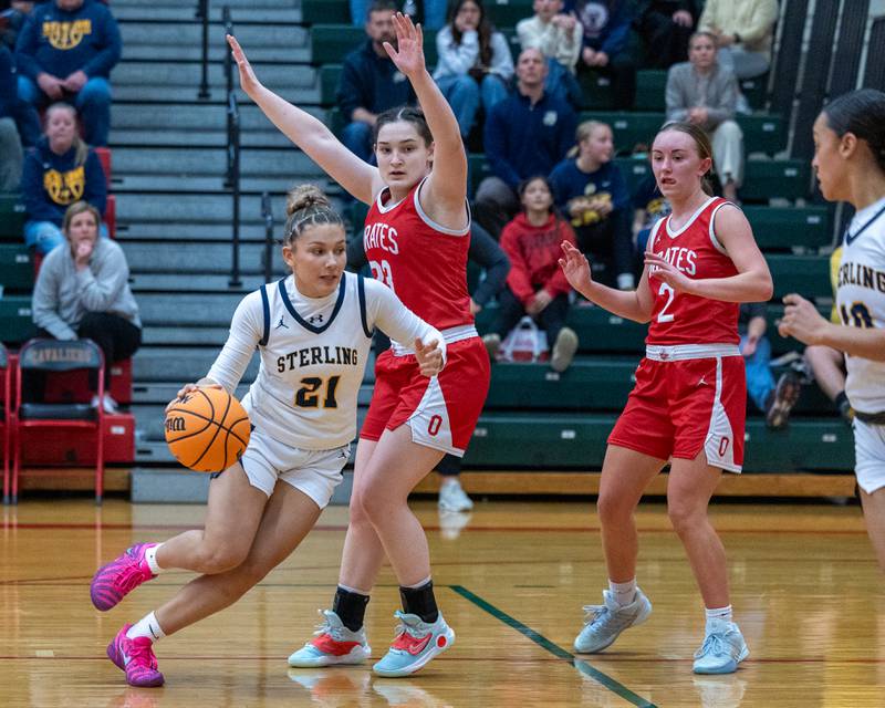 Jaelynn James (21) of Sterling drives ball in lane as Mary Stisser (23) of Ottawa defends during Regional Championship game on Thursday, Feb. 19, 2026 in Sellett Gymnasium at L-P High School.