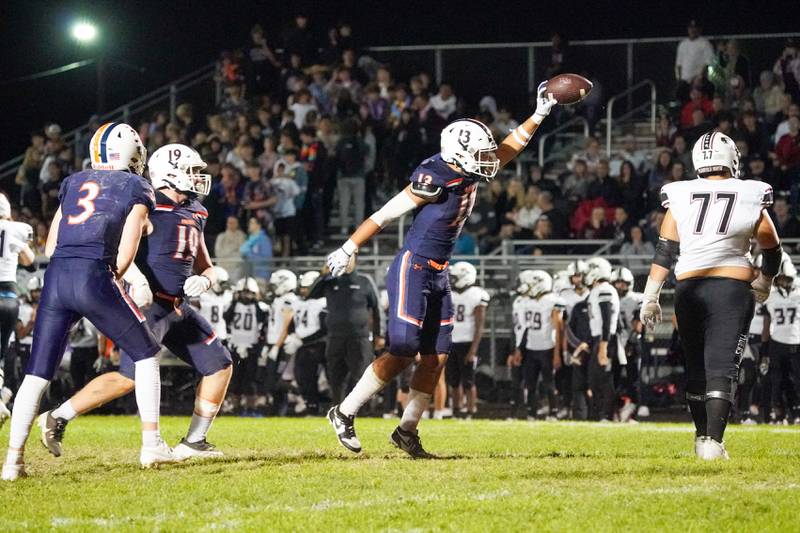 Oswego’s Jordan Sweiss (13) celebrates after recovering a fumble during a football game against Plainfield North at Oswego High School on Friday, Sept. 27, 2024.