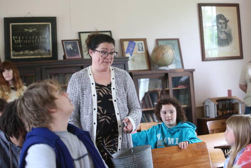 Museum Director Amanda Carter shares the history of Aitken School with Bureau County Special Schools BEST Program students on Tuesday, May 20, 2025, at the La Salle County Historical Society's one-room schoolhouse in Utica.