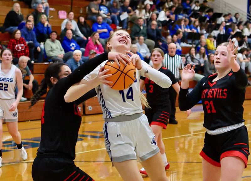 Princeton's Payton Brandt gets a helping hand from Hall's Natalia Zamora in Tuesday's game at Prouty Gym. The Tigresses won 41-39.
