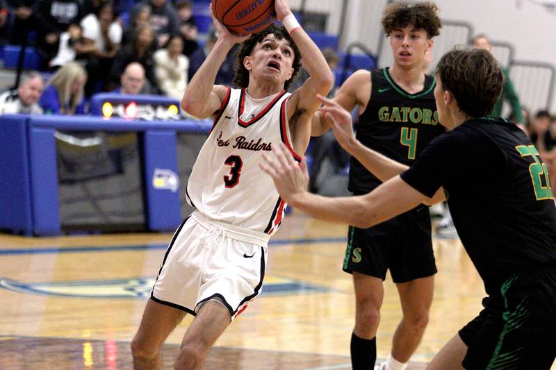 Huntley’s Lucas Crosby looks to the hoop against Crystal Lake South in varsity basketball tournament title game action at Johnsburg Friday.