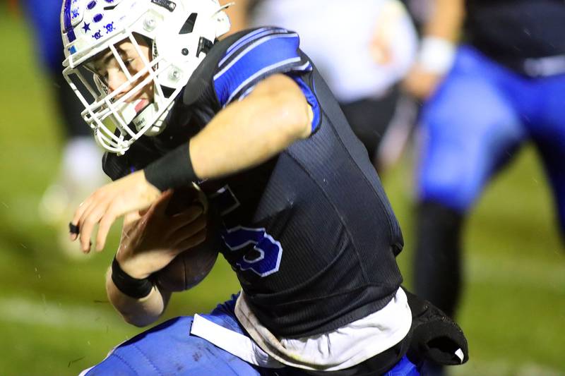 Burlington Central’s Parker Auxier moves the ball against Harlem in IHSA football Class 6A second-round playoff action at Central High School in Burlington on Saturday, November 8, 2025.