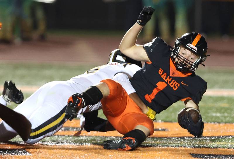 DeKalb's Talen Tate falls into the end zone for a touchdown with a Metea Valley defender in tow during their game Friday, Sept. 16, 2022, at DeKalb High School.