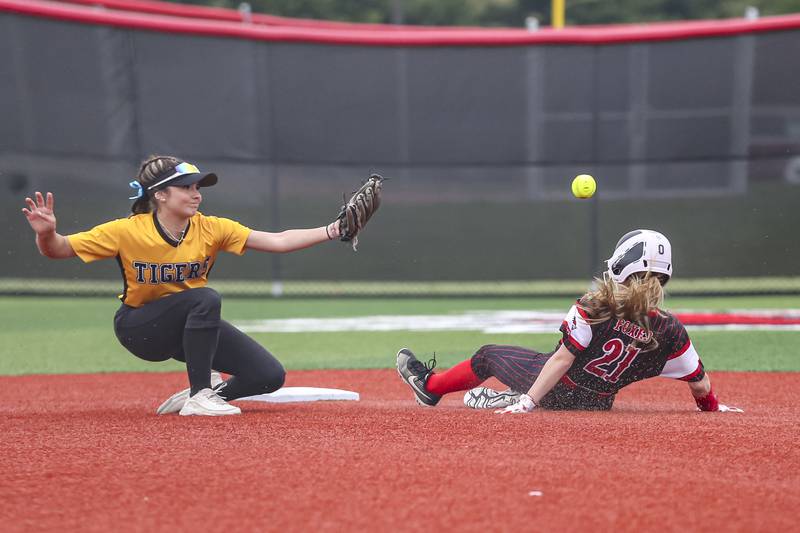 Yorkville's Isla Eidsness (21) slides into second as the throw gets away from Joliet West's Mallory Crisafulli (9) during softball game between Joliet West at Yorkville on Wednesday, April 30, 2025 in Yorkville.