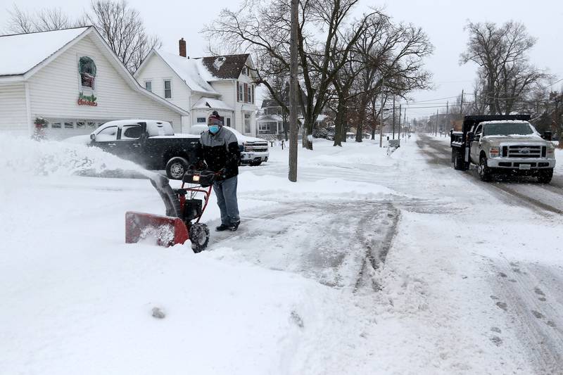 Ray Bober of Huntley uses a snowblower to clear his property on Tuesday, Jan. 26, 2021 in Huntley.