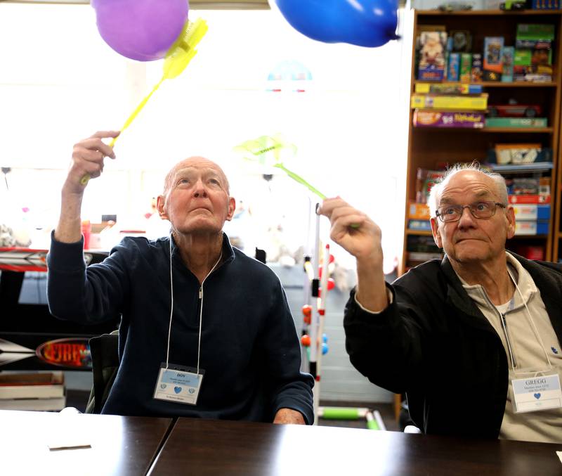 Don P. (left) and Gregg E. bat at balloons during a program at the Elderday Center in Batavia. The center, which offers therapeutic care for seniors will celebrate 35 years of service this year.