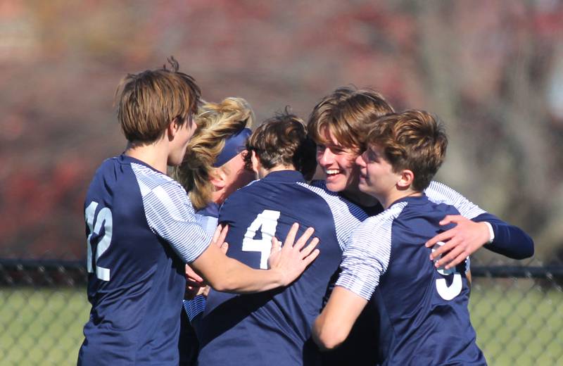 Cary-Grove’s Ethan Doyle is mobbed by teammates after scoring against Harvard in IHSA Class 2A Regional Title Game soccer action on Saturday, Oct. 26, 2024, at  Harvard Junior High School  in Harvard.